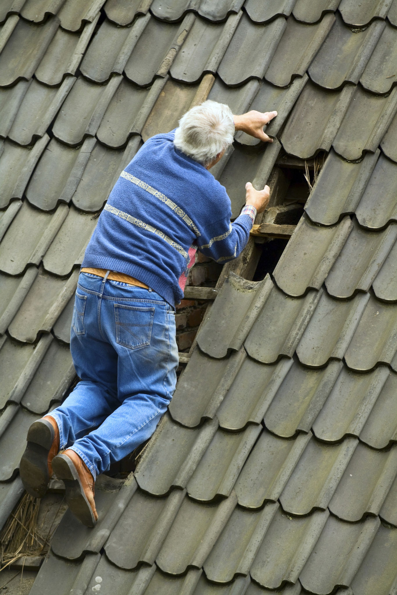 Senior man is reparing roof Senior man is reparing roof