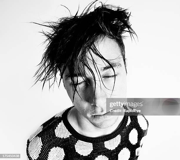 bizarre looking young man with bedhead hair and closed eyes - emo guy stock pictures, royalty-free photos & images