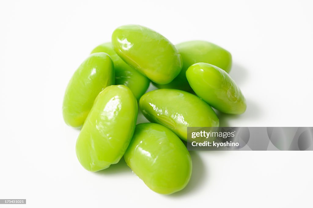 Isolated shot of stacked boiled green soybeans on white background