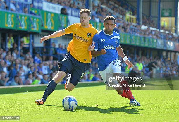 Scott Davies of Oxford battles with Andy Barcham of Portsmouth during the Sky Bet League Two match between Portsmouth and Oxford United at Fratton...
