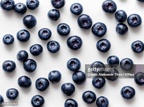 close-up of blueberries on white background - blueberries fruit stock pictures, royalty-free photos & images