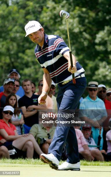 Keegan Bradley reacts to an eagle putt on the second green during the Third Round of the World Golf Championships-Bridgestone Invitational at...