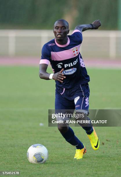Evian's Ghanaian midfielder Mohammed Rabiu runs with the ball during the French L1 friendly football match Evian vs Cannes on August 3, 2013 at the...