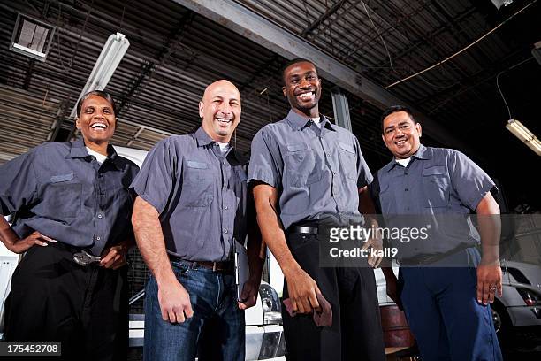 multi-ethnic workers at trucking facility - four people smiling stock pictures, royalty-free photos & images