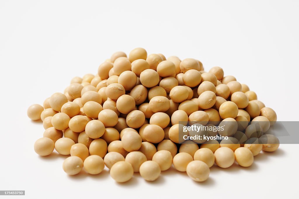 Isolated shot of stacked dried soybeans on white background