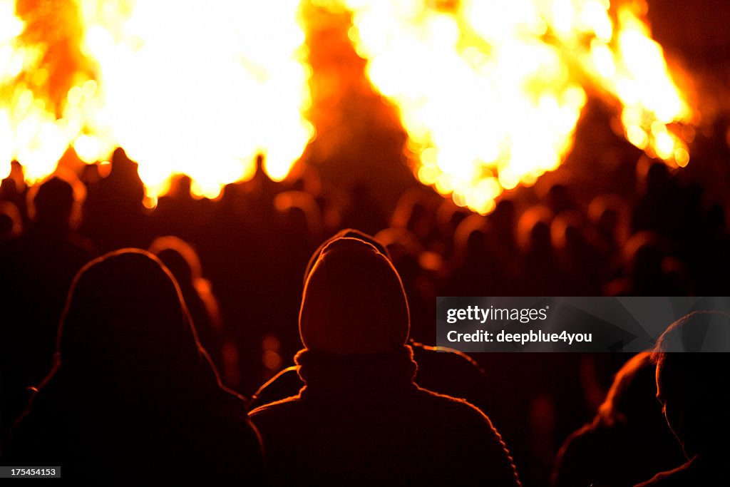 Silhouette of people on fire at night