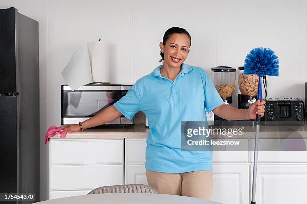 woman cleaning a corporate break room - feather duster stock pictures, royalty-free photos & images
