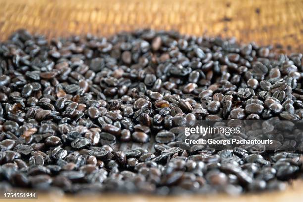 dark roasted coffee beans - moving toward stock pictures, royalty-free photos & images