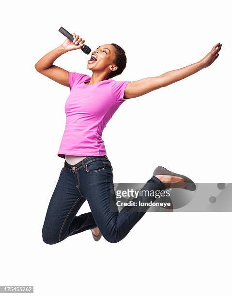 afroamericana mujer salto mientras canta en mike aislado - women dancing on music cutout fotografías e imágenes de stock