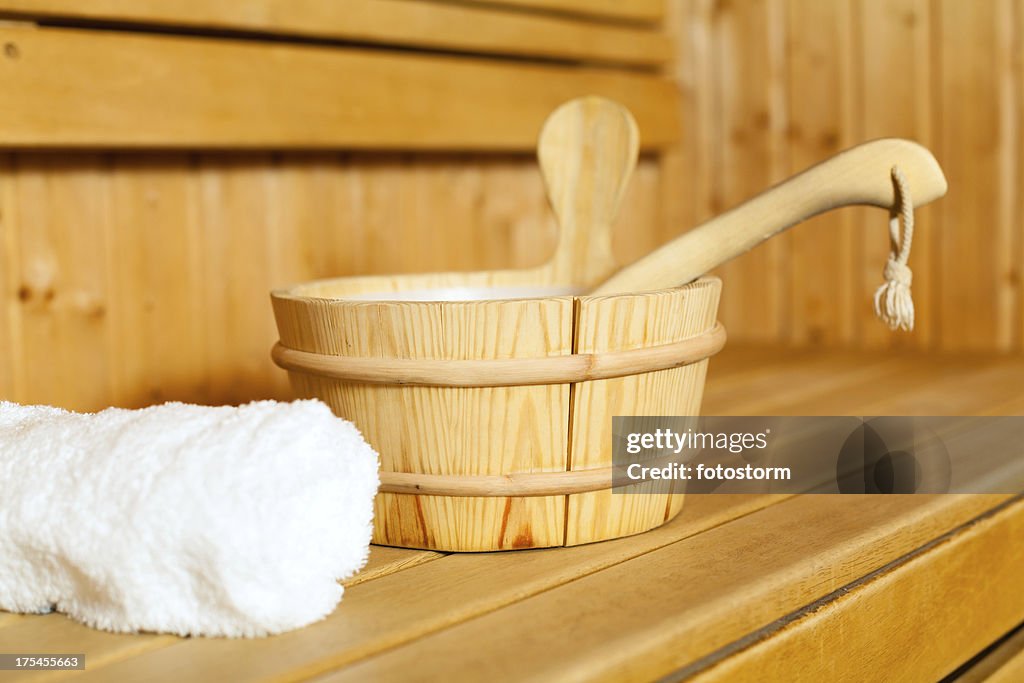 Close-up of towel, bucket and ladle in sauna