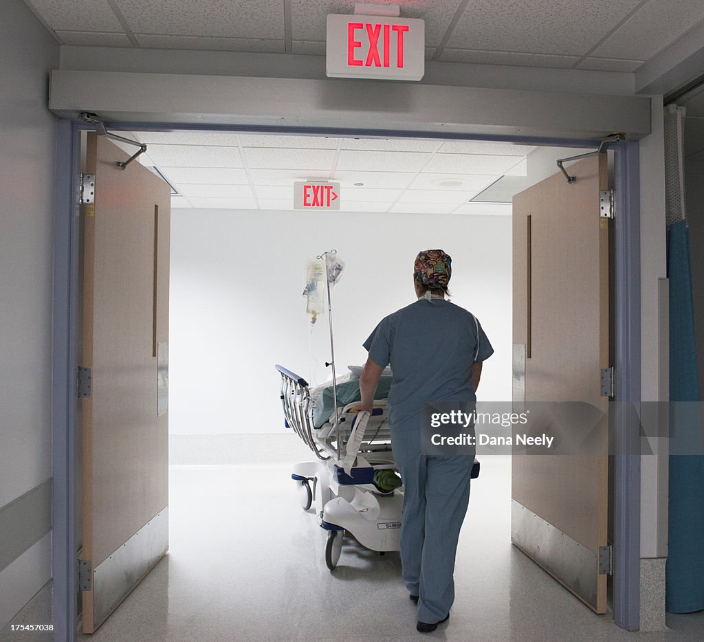 Nurse pushing patient into surgery.