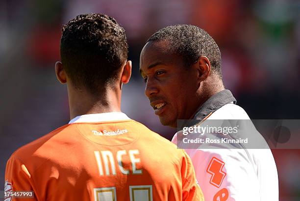 Tom Ince of Blackpool with his manager Paul Ince during the Sky Bet Championship match between Doncaster Rovers and Blackpool at Keepmoat Stadium on...