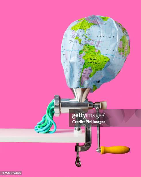 globe in a meat grinder - contracting stock pictures, royalty-free photos & images