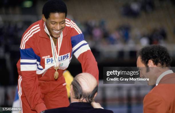 Javier Sotomayor of Cuba on the winners' podium after taking the gold medal in the High Jump at the 1989 IAAF World Indoor Championships in Budapest,...