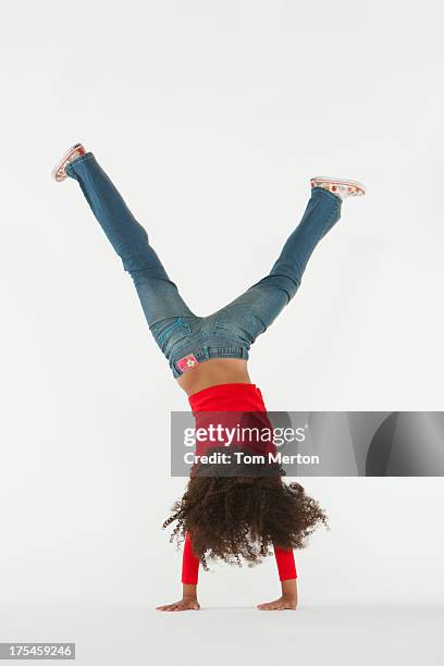 young girl doing cartwheel indoors - cartwheel stock pictures, royalty-free photos & images