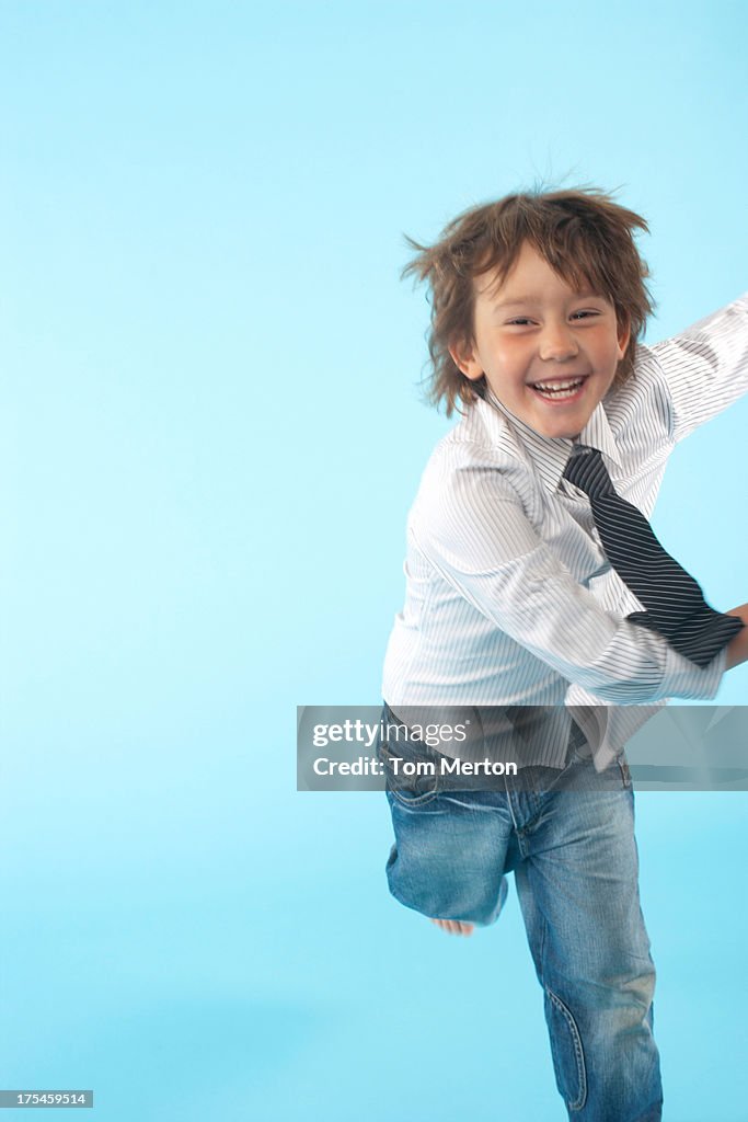 Young boy indoors wearing shirt and tie