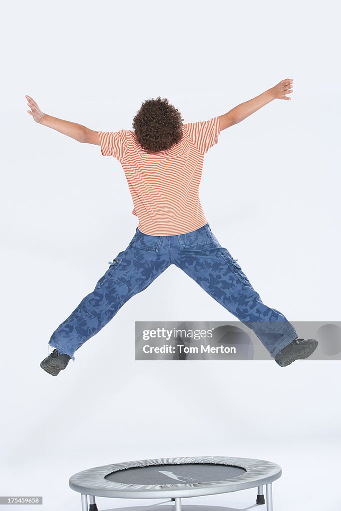 Young boy jumping indoors