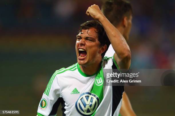 Marcel Schaefer of Wolfsburg celebrates his team's third goal during the DFB Cup first round match between Karlsruher SC and VfL Wolfsburg at...