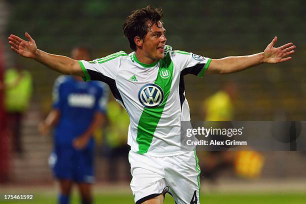 Marcel Schaefer of Wolfsburg celebrates his team's third goal during the DFB Cup first round match between Karlsruher SC and VfL Wolfsburg at...