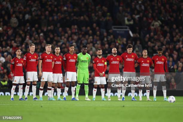 Manchester United players hold a minutes silence in tribute to former player Sir Bobby Charlton prior to the UEFA Champions League match between...