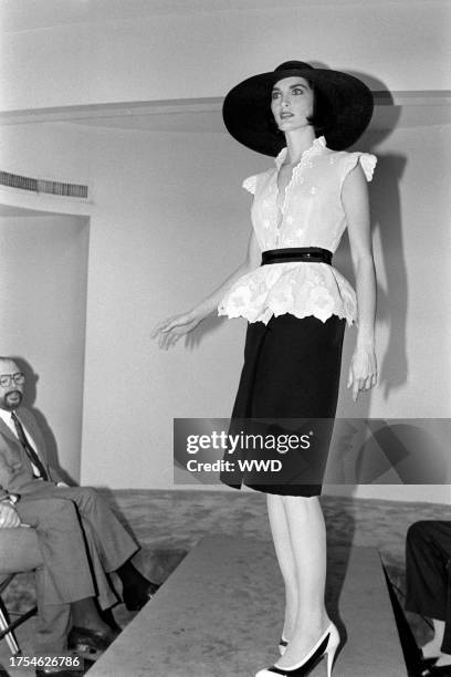 Model Margaret Donohoe presents an ensemble from the spring 1985 ready to wear collection inside of designer Pauline Trigère's New York City showroom.