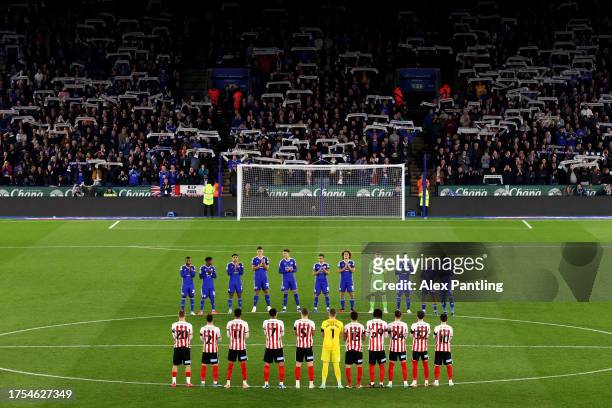 Players, officials and fans hold a minutes applause in memory of former Leicester City owner Vichai Srivaddhanaprabha prior to the Sky Bet...