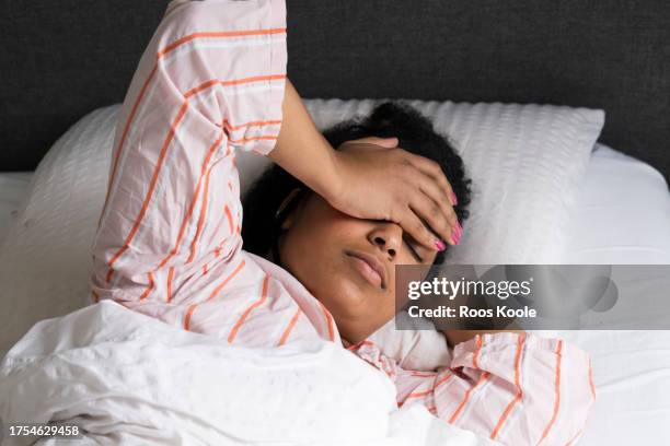 young woman in bed - insomnia stock-fotos und bilder