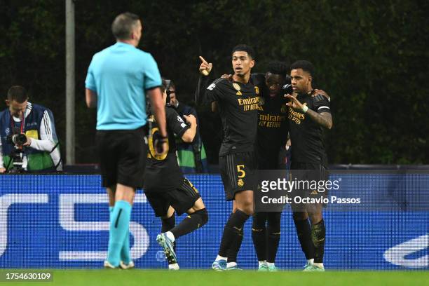 Rodrygo of Real Madrid celebrates with teammates Jude Bellingham and Vinicius Junior after scoring the team's first goal during the UEFA Champions...
