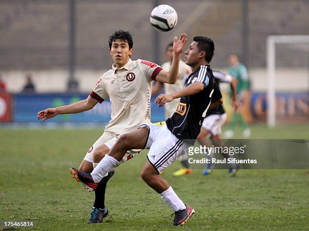 Irvin Acuna of Sporting Cristal fights for the ball with Angel Romero of Universitario during a match between Universitario and Sporting Cristal as...