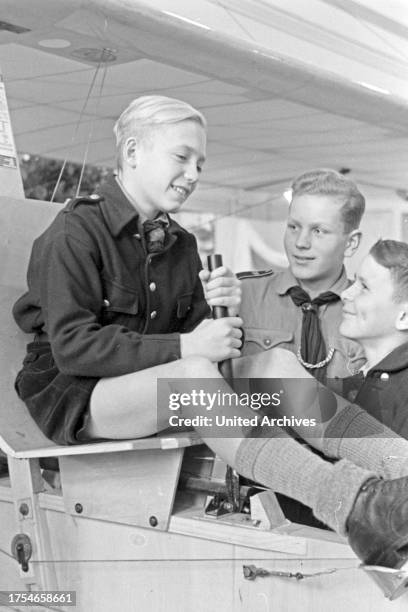 Hitler youth at the steering stick of a glider at the Wehrmacht exhibition, Germany 1940s.