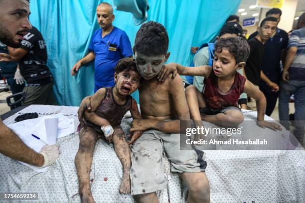 Palestinians injured in Israeli air raids arrive at Nasser Medical Hospital on October 24, 2023 in Khan Yunis, in the southern Gaza Strip, Gaza. Two...