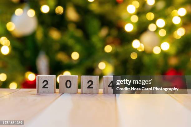 2024 on wood block with christmas light - hello january stock pictures, royalty-free photos & images