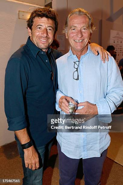 Singer Patrick Bruel and presenter William Leymergie attend "Pianistic" Concert of singer Julien Clerc at at 29th Ramatuelle Festival : Day 4 on...