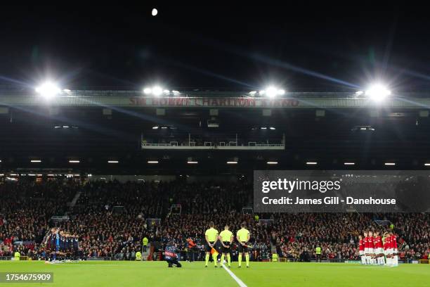 Players of Manchester United and FC Copenhagen take part in a minute's silence in memory of Sir Bobby Charlton during the UEFA Champions League match...