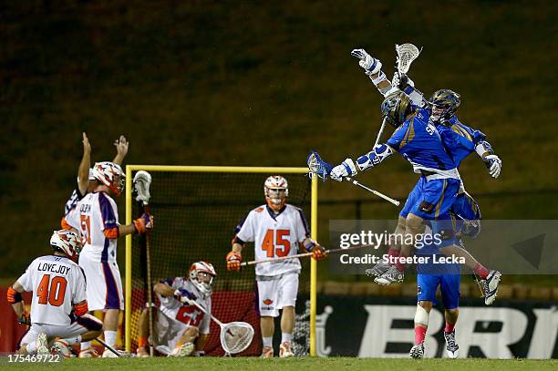 Ryan Young celebrates scoring a goal with teammate Mike Sawyer of the Charlotte Hounds during their game against the Hamilton Nationals at American...