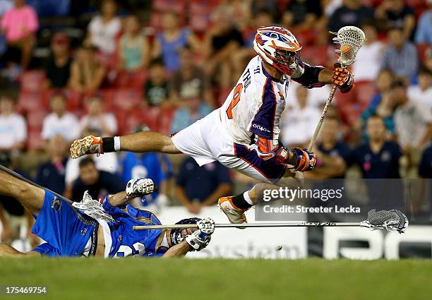 Garrett Thul of the Hamilton Nationals jumps over Ryan Flanagan of the Charlotte Hounds during their game at American Legion Memorial Stadium on...