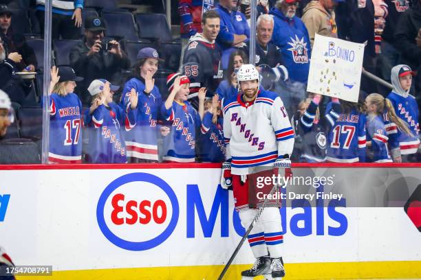 Blake Wheeler of the New York Rangers is all smiles during the pre-game warm up as young fans cheer him on prior to NHL action against the Winnipeg...