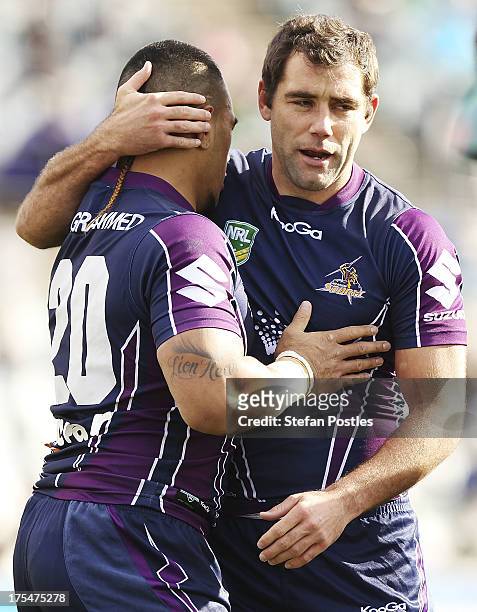 Mahe Fonua of the Storm is congratulated by Cameron Smith after scoring a try during the round 21 NRL match between the Canberra Raiders and the...