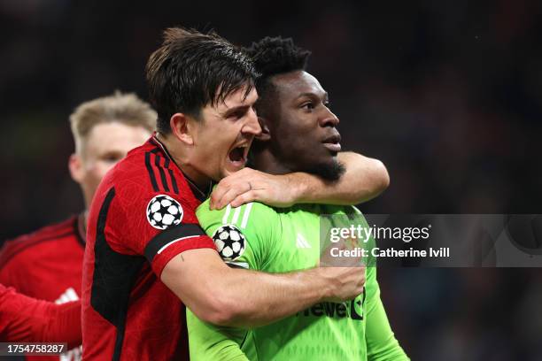 Andre Onana and Harry Maguire of Manchester United celebrate after saving a penalty from Jordan Larsson of FC Copenhagen during the UEFA Champions...