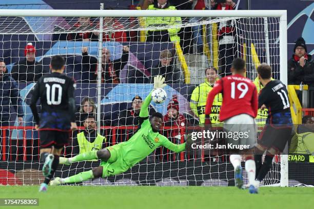 Andre Onana of Manchester United saves a penalty by Jordan Larsson of FC Copenhagen during the UEFA Champions League match between Manchester United...