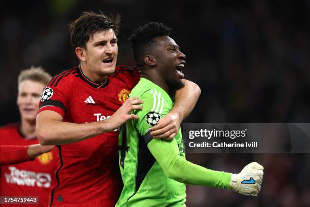 Andre Onana and Harry Maguire of Manchester United celebrate after saving a penalty from Jordan Larsson of FC Copenhagen during the UEFA Champions...