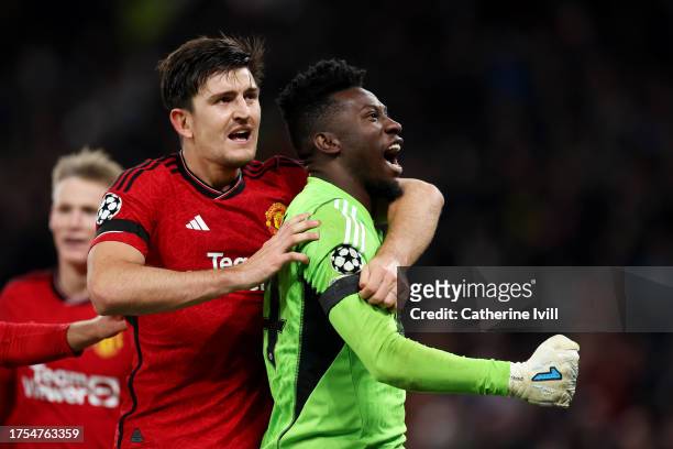Andre Onana and Harry Maguire of Manchester United celebrate after saving a penalty from Jordan Larsson of FC Copenhagen during the UEFA Champions...