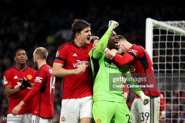 Andre Onana and Harry Maguire of Manchester United celebrate after saving a penalty from Jordan Larsson of FC Copenhagen during the UEFA Champions...