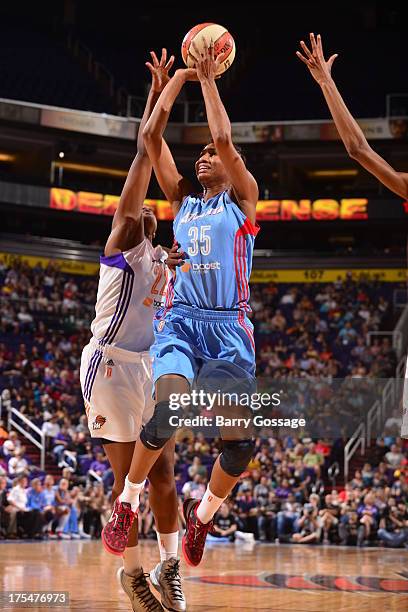 Angel McCoughtry of the Atlanta Dream shoots against Charde Houston of the Phoenix Mercury on August 3, 2013 at U.S. Airways Center in Phoenix,...