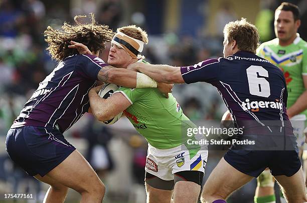 Joel Edwards of the Raiders is tackled during the round 21 NRL match between the Canberra Raiders and the Melbourne Storm at Canberra Stadium on...