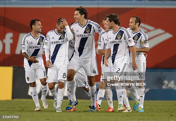 Los Angeles Galaxy's Omar Gonzalez celebrates with teammates after scoring the first goal against Italian football side Juventus at the Guinness...