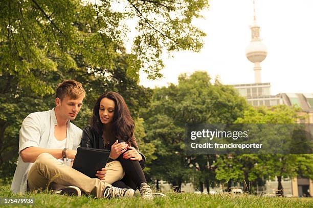 couple of lovers surfing on social media app in berlin - berlin park stock pictures, royalty-free photos & images