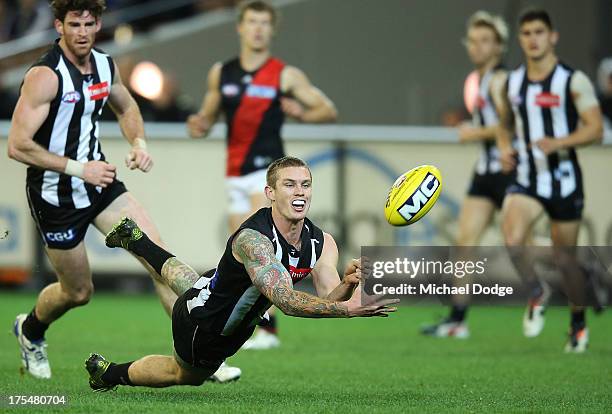 Dayne Beams of the Magpies handpasses the ball during the round 19 AFL match between the Collingwood Magpies and the Essendon Bombers at Melbourne...