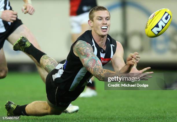 Dayne Beams of the Magpies handpasses the ball during the round 19 AFL match between the Collingwood Magpies and the Essendon Bombers at Melbourne...