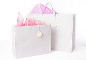 Two blank shopping bags with tag on white background